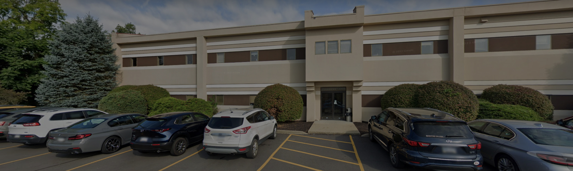 McMurray Family Dental building exterior with parked cars in front lot.